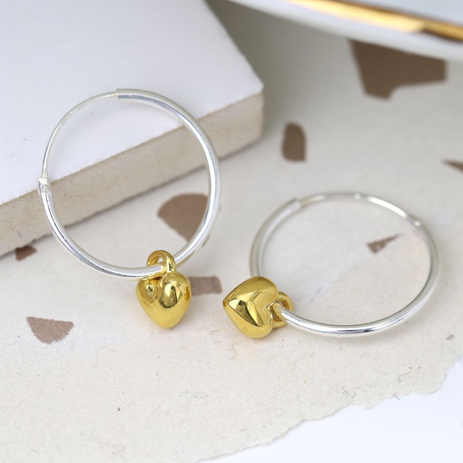 Sterling silver hoop earrings with gold hearts